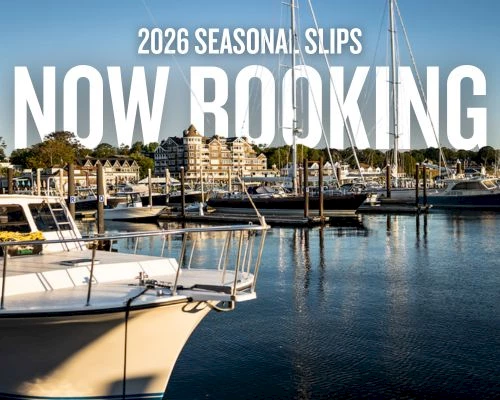 A marina with boats and sailboats docked, calm water reflecting the harbor, bold white text announcing &ldquo;NOW BOOKING&rdquo; and &ldquo;2026 SEASONAL SLOTS.&rdquo;